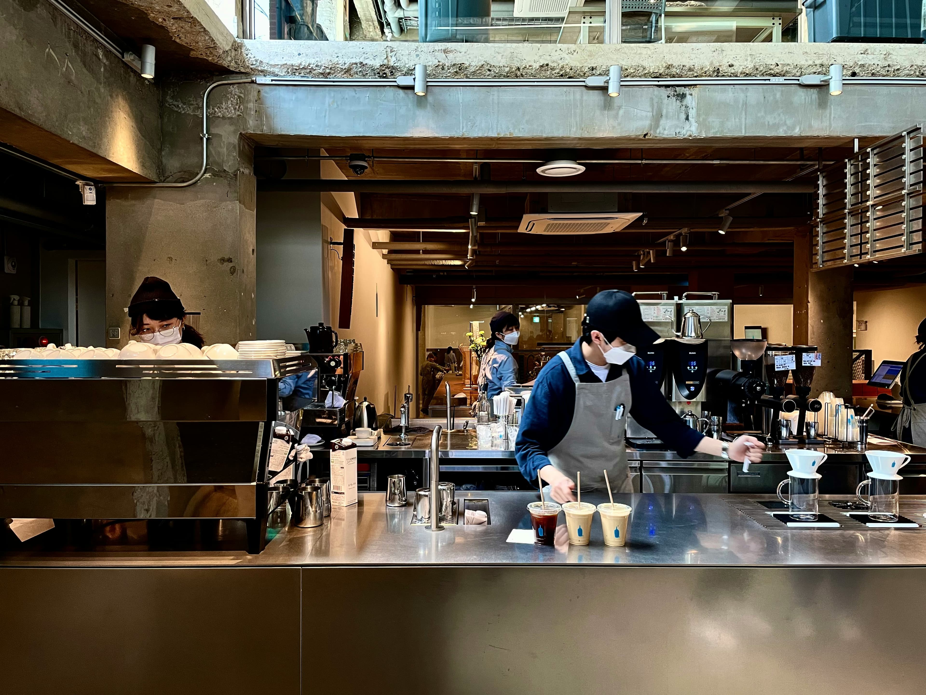 Baristas preparing coffee at a Seongsu-dong warehouse cafe in Seoul